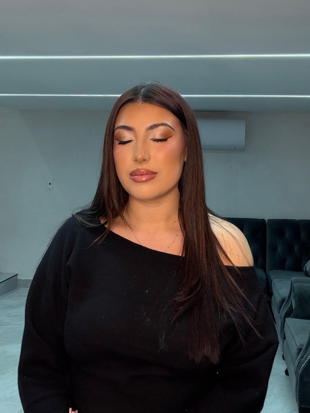 Client with eyes closed showing a warm bronze smoky eye