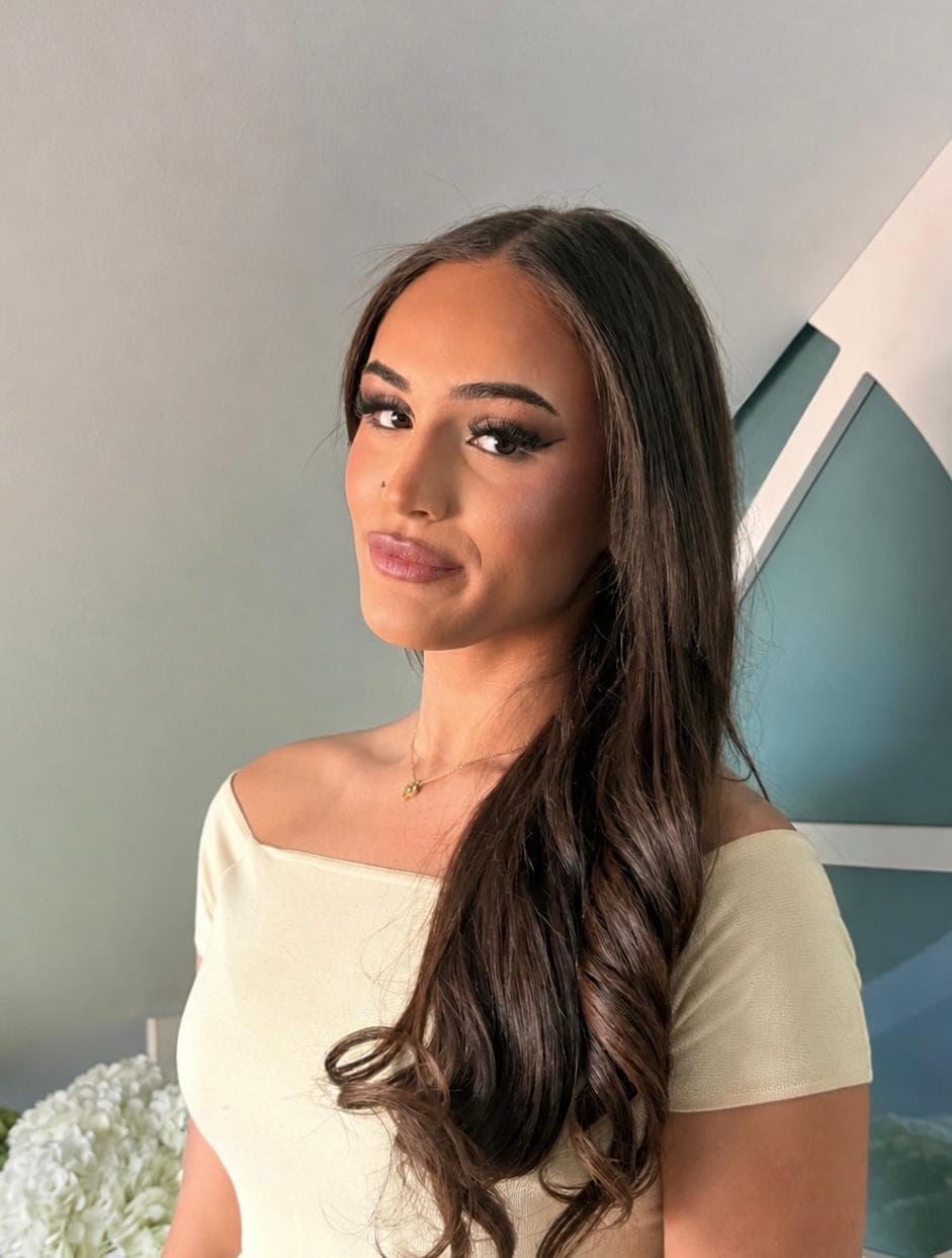 Client wearing a sharp winged liner and glossy pink lip