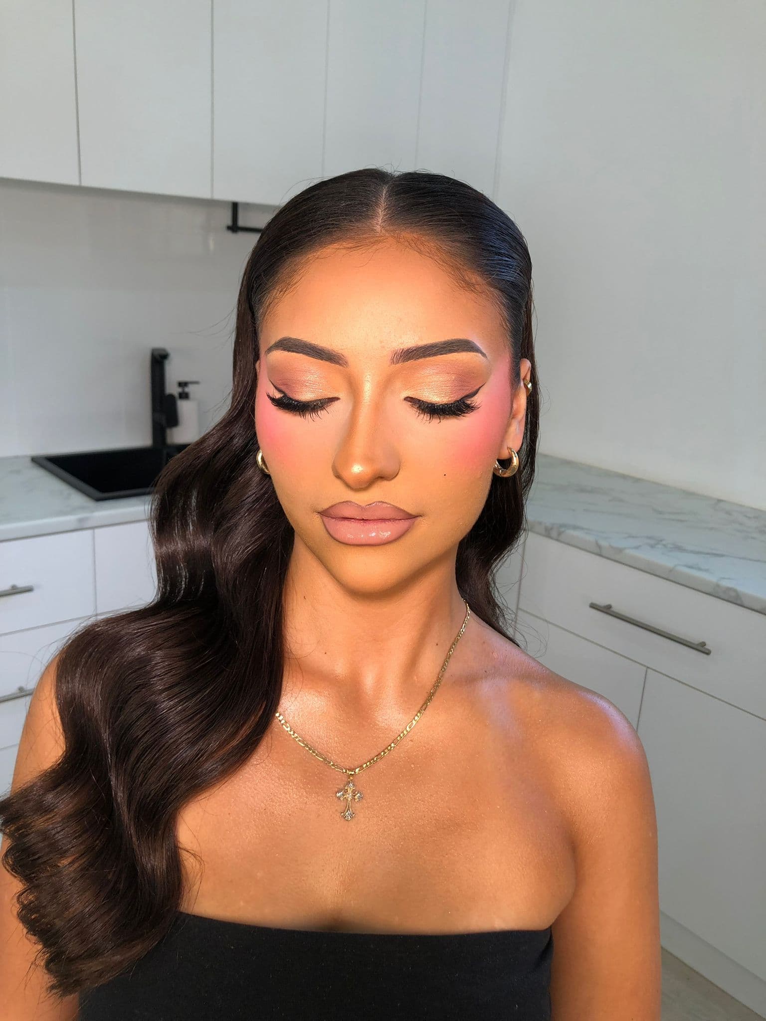 Client with eyes closed showing a champagne shimmer lid and lashes