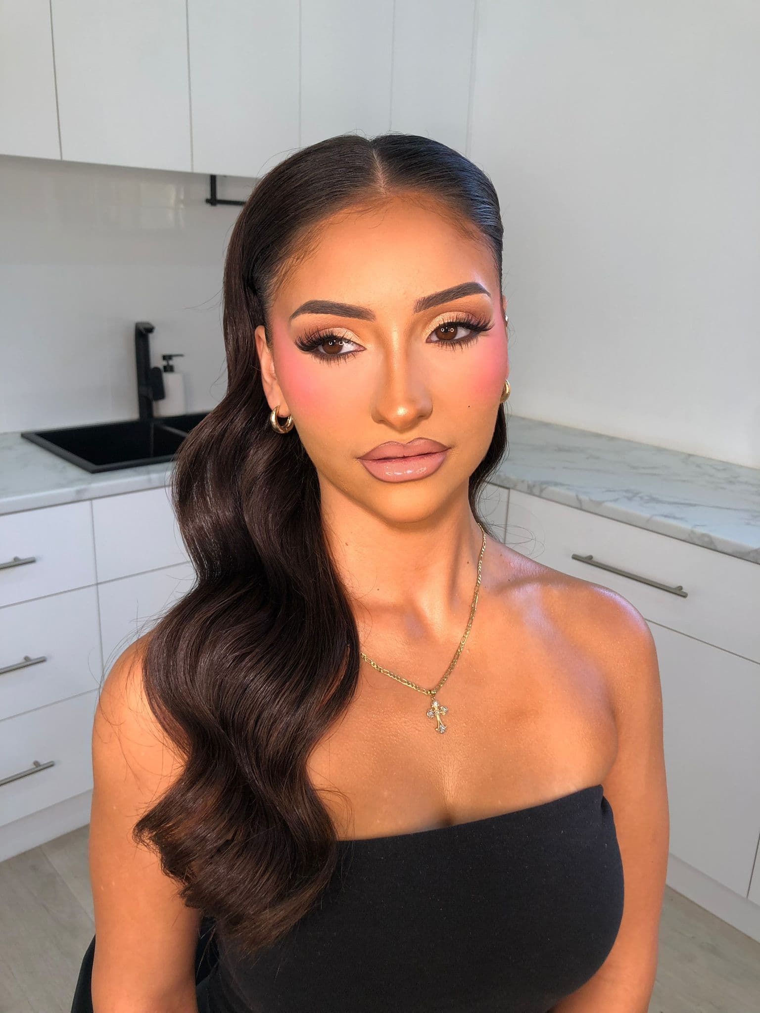 Client wearing soft glam with a nude lip and gold hoops